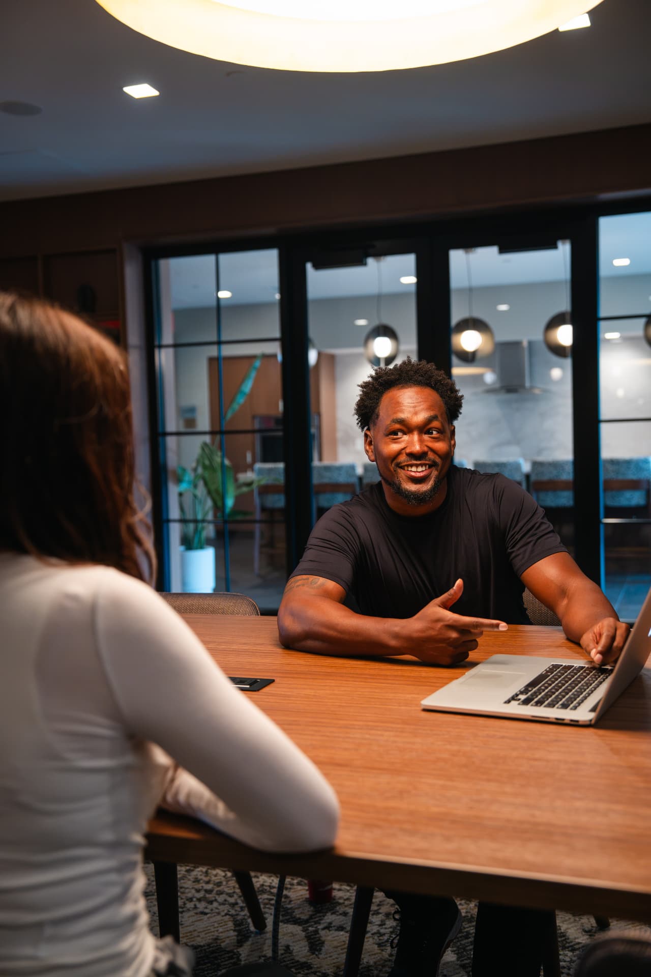 A trainer talking through training goals with a client at a table